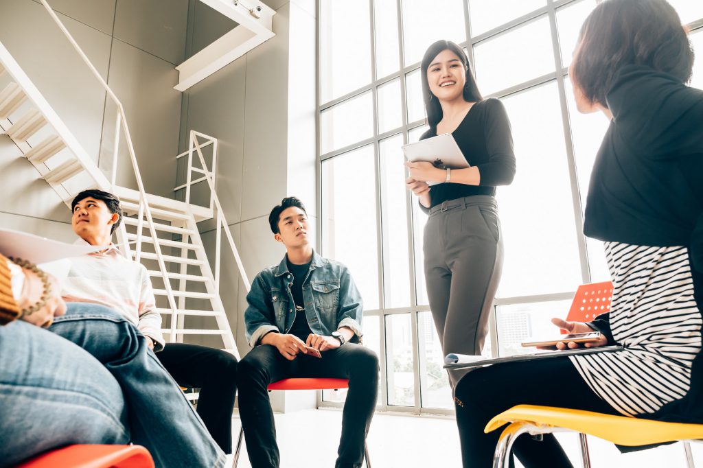 Coworkers discussing in meeting room at the office